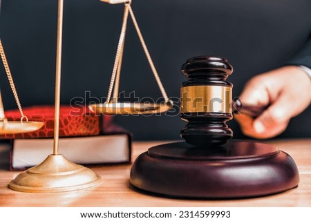 Judge gavel and scales of justice with lawyer book attorney judge hand in court background with wooden table. Law court and judgment concept. Courthouse government theme. Civil Court Criminal Court Royalty-Free Stock Photo #2314599993