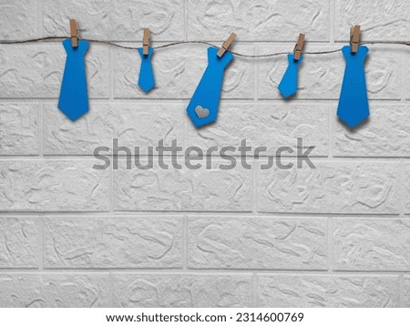 Preparing, celebrating Father's Day, party, Love Your Lawyer Day. Decorative garland with blue paper-cut ties. simple DIY home decorating idea. Copy space. Template for greeting card, article, advert.