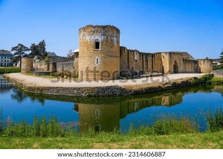 Reflection of the round corner tower of the medieval castle of Brie Comte Robert in the water-filled moat in the French department of Seine et Marne in the capital region of Ile-de-France near Paris