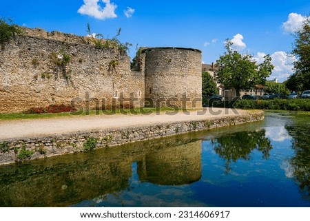 Water-filled moat below the round corner tower of the medieval castle of Brie Comte Robert in the French department of Seine et Marne in the capital region of Ile-de-France near Paris