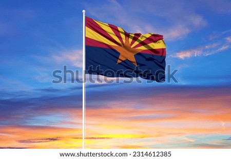 Arizona  flag on flagpoles and blue sky
