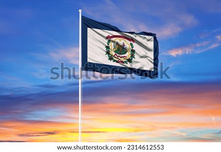  West Virginia  flag on flagpoles and blue sky

