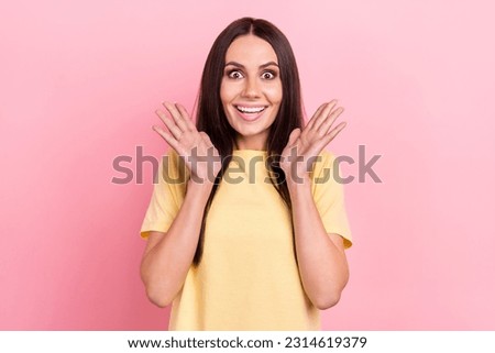Photo of excited funny lady raise arms air hear amazing news glad delighted wear yellow shirt isolated pink color background