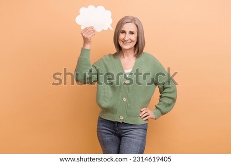 Photo of satisfied old senior business developer woman hold paper bubble cloud her speech message announce isolated on beige color background Royalty-Free Stock Photo #2314619405