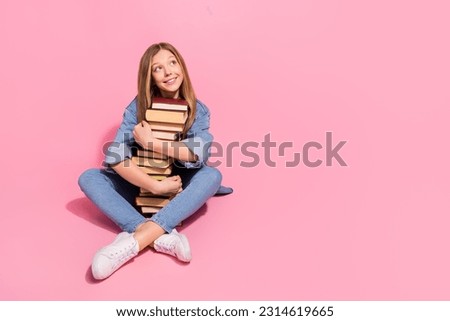 Photo of cheerful dreamy girl wear trendy jeans clothes sit floor hug hold many books look empty space isolated on pink color background Royalty-Free Stock Photo #2314619665
