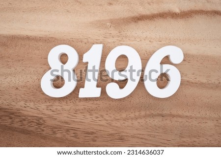 White number 8196 on a brown and light brown wooden background.
