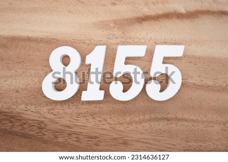 White number 8155 on a brown and light brown wooden background.