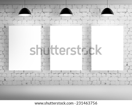 three blank posters on brick wall