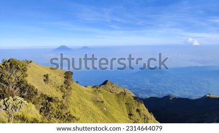 Landscape view from the top of Mount Merbabu. Seen from a distance Mount Sumbing and Mount Sindoro in Central Java, Indonesia with a clear blue sky. Aerial view