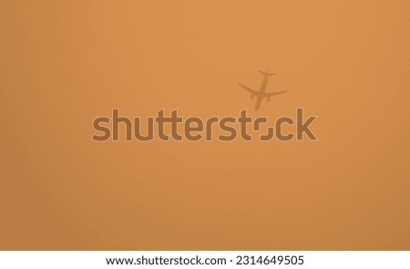 hazy sky with airplane flying in smoke condition, brooklyn, new york city (haze, smoky, smog from wildfires in nova scotia, canada) pollution from fire, yellow sky Royalty-Free Stock Photo #2314649505