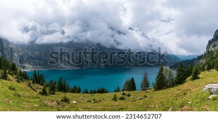 Amazing tourquise Oeschinnensee with waterfalls and Swiss Alps, Kandersteg, Berner Oberland, Switzerland. Royalty-Free Stock Photo #2314652707