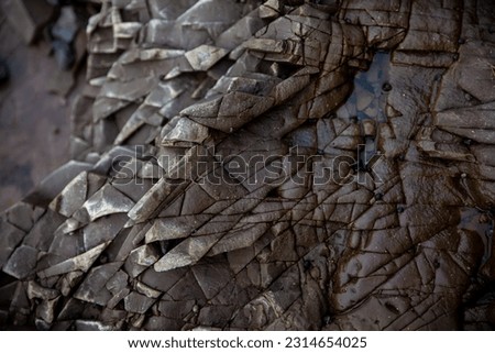 cracked rock texture. Black white stone background. Dark grey rough surface. A background image of a concrete shape of broken, damaged, and collapsed stone