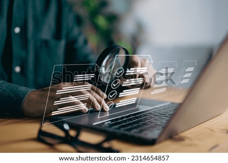 A man examines a paper using a magnifying lens, representing business analysis, auditing, professional document review, inquiry, and inspection, all essential concepts in the field. Royalty-Free Stock Photo #2314654857