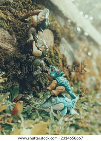 action figure. dinosaur toys arranged like they were working together to climb