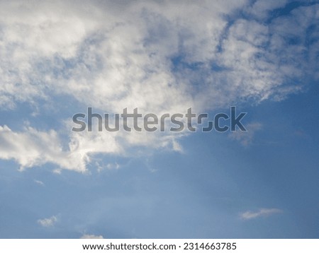 Photo of a blue sky with white clouds