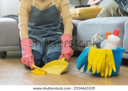 Household hygiene clean up, housekeeper woman hand in pink rubber protective gloves with yellow broom and dustpan sweeping remove dust on floor at home, equipment or tool for cleaning, cleaner people. Royalty-Free Stock Photo #2314665529