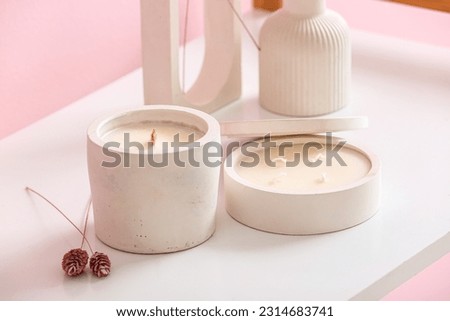 Holders with candles and decor on table in room, closeup Royalty-Free Stock Photo #2314683741