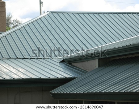 a green metal roof in the sun  Royalty-Free Stock Photo #2314690047