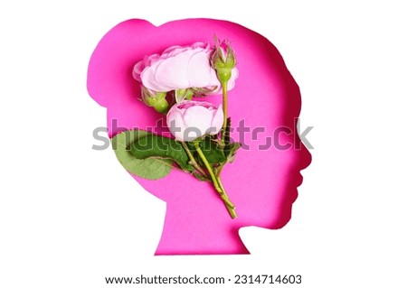 Abstract composition featuring the pink silhouette of a female face in profile, adorned with soft fresh roses on a white background, creating a stunning multi-exposure effect.