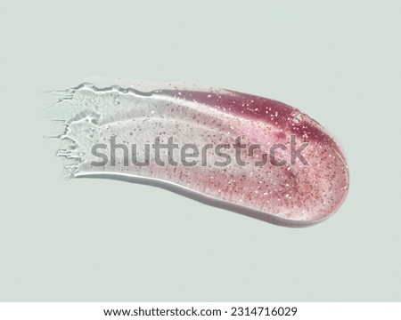 Lip gloss or oil gel with shimmer texture smudge on sage background Royalty-Free Stock Photo #2314716029
