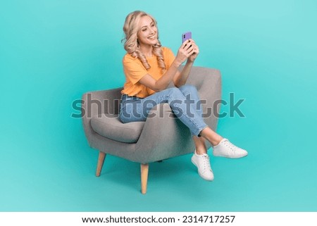 Full length photo of girly cute lady dressed orange t-shirt texting instagram twitter telegram facebook isolated teal color background