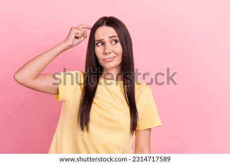 Photo of suspicious unsure woman dressed yellow t-shirt finger head looking empty space isolated pink color background Royalty-Free Stock Photo #2314717589