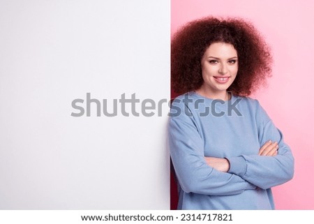 Photo of pretty confident woman dressed blue sweatshirt arms crossed placard empty space isolated pink color background
