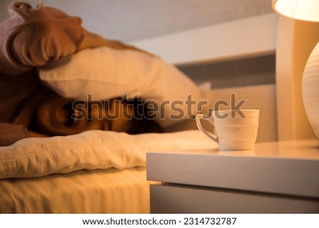 Closeup image of a beautiful young asian woman smelling and drinking hot coffee