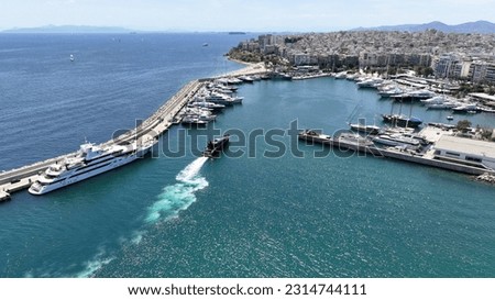 Aerial drone photo of beautiful yacht manoeuvring inside round port of Zea or Passalimani a safe anchorage in seaside area of Piraeus, Attica, Greece
