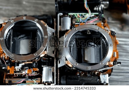 DSLR photographic and video digital camera body interior repair by technician or engineer, camera and technology equipment maintenance and repair concept, old SLR crop sensor mirror Camera fixation