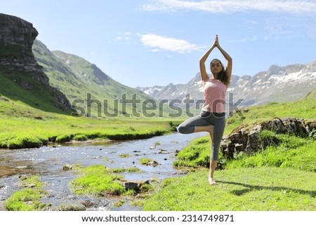 Front view portrait of a yogi practicing yoga in a river side