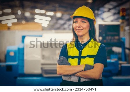 Factory female worker. Engineer woman worker with laptop working in plant production checking and testing machine in smart factory wearing yellow hard hat safety first at mechanic factory.