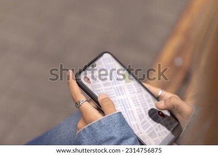 Map on smartphone. Hands of young woman. Guide in the city