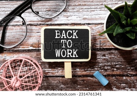 A sign saying back to work. The felt sign has removable letters than can be moved around to make whatever words or saying one wants.