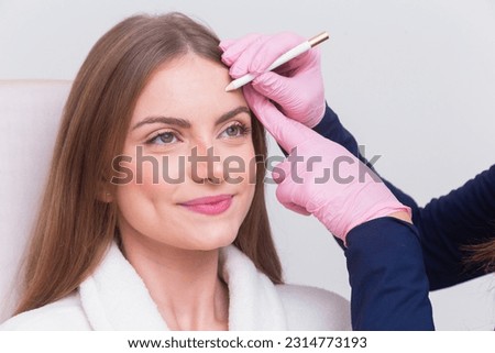 Woman wearing bathrobe in beauty clinic, aesthetics, patient, cosmetic procedures. botox application. anti wrinkle and anti aging. Royalty-Free Stock Photo #2314773193