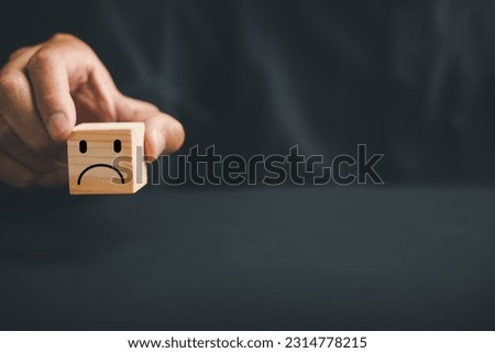 Unsatisfied customer expressing dissatisfaction on a wooden block. Concept of bad product quality, low rating, and negative comment. The impact of unsatisfied customers on business reputation. Royalty-Free Stock Photo #2314778215