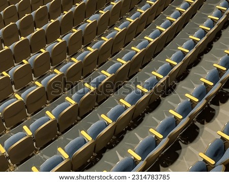 Empty gray and blue theater, auditorium seats, chairs.
