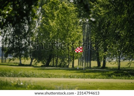 red and white checkered flag in golf course
