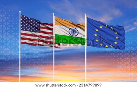 Three realistic flags of European Union, United States and India on flagpoles and blue sky