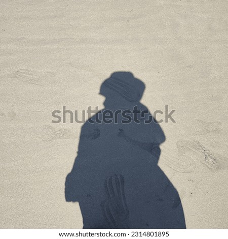 Silhouette Photo of a Woman Wearing a Dress and Hat on the Beach