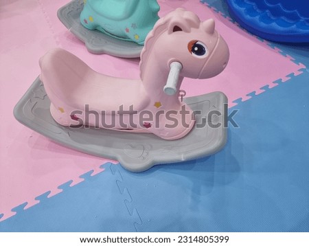 rocking horse toy for kids made of pink plastic