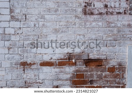 A distressed,  grungy,  partly whitewashed brick wall full of texture for background. Royalty-Free Stock Photo #2314821027
