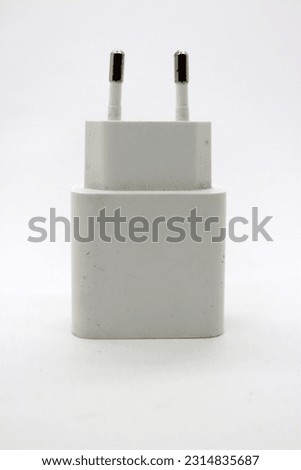 White cellphone charger adapter on the floor