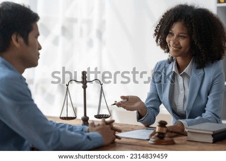 Lawyer or legal advisor reading restrictions Counseling between American female lawyers Africans with business clients Financial firms, tax, legal accounting, justice contract signing documents. Royalty-Free Stock Photo #2314839459