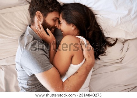 Smile, bedroom hug and happy couple laughing at funny joke, relationship humour or home comedy in Spain. Marriage happiness, love bond and top view of relax man, woman or morning people laugh in bed Royalty-Free Stock Photo #2314840275