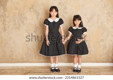 Cute sisters in black dresses.