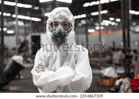 Industrial waste inspector wearing personal protective equipment to check hazardous chemicals, radioactive and toxic substances. Analyzing impact of factory's current projects, suggesting solutions. Royalty-Free Stock Photo #2314867339