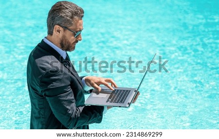man trader work and relax in swimming pool, copy space. man trader work and relax with laptop.