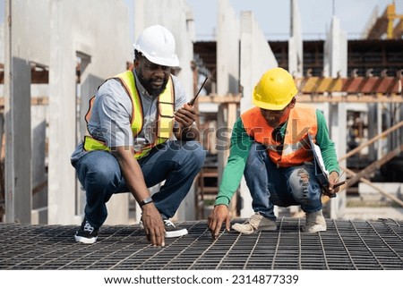 Portrait African American and Asia engineer man checking wire mesh with precast cement factory background Royalty-Free Stock Photo #2314877339