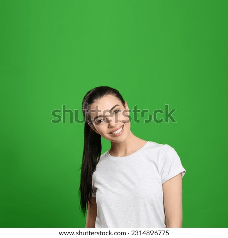 Chroma key compositing. Pretty young woman with dark hair against green screen